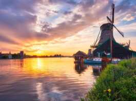 Windmills At Zaanse Schans In Holland On Sunset.