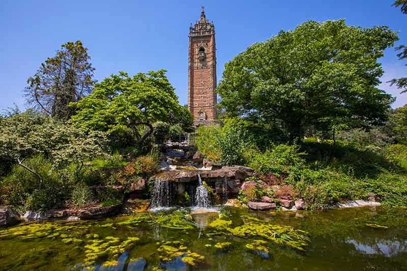 cabot tower with waterfall and greenery