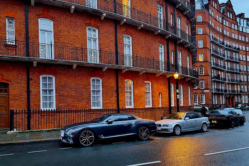 luxury cars parked in a London residential street