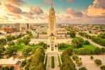 20 things to do in Lincoln Nebraska that locals love aerial view of the lincoln city skyline with the capitol building in the centre at dusk