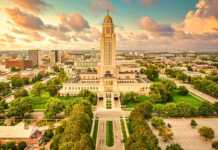 aerial view of the lincoln city skyline with the capitol building in the centre at dusk