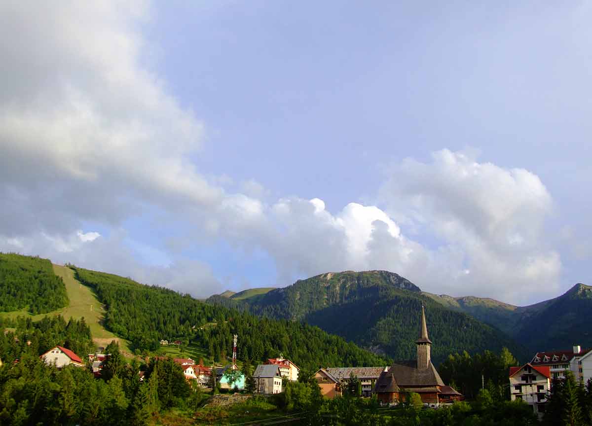 5 cities in romania Alpine resorts and traditional wood church.