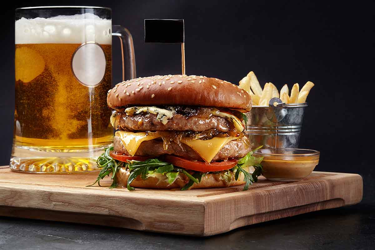 American beer pale ale and a juicy burger on a board