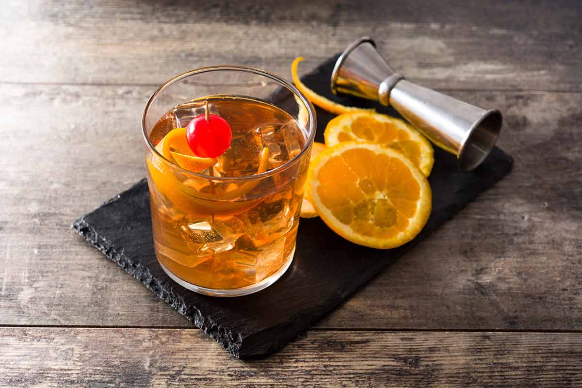 American cocktails old fashioned with orange and cherry