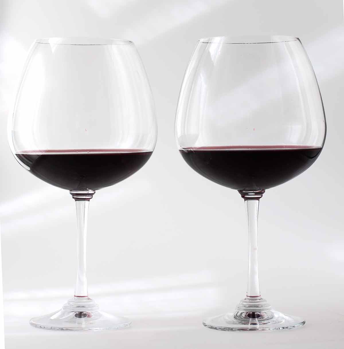 American drinks wine two glasses of red wine over white background