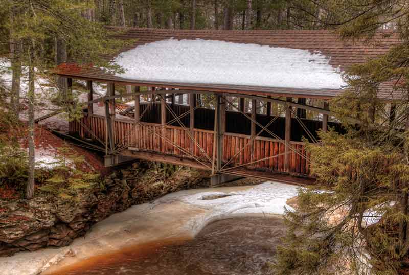 bridge with snow-covered roof in Amnicon Falls State Park Wisconsin