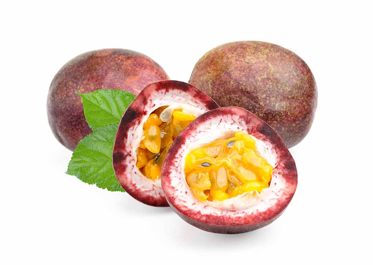 two whole passion fruit and two half passion fruit on white background