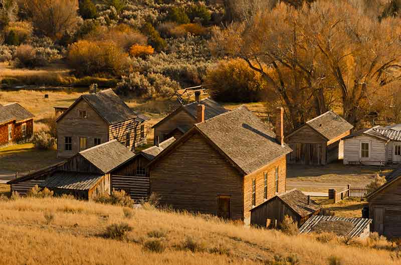 sunlight streaming on the buildings in Bannack State Park Montana