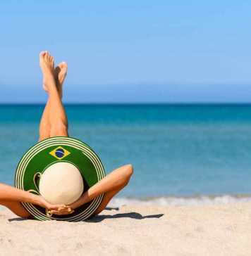 Beaches Brazil nude woman wearing a wide-brimmed hat with Brazil's flag