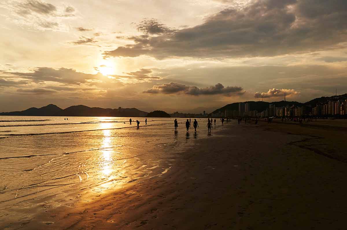 Beaches in Brazil golden sunset with people walking in the distance