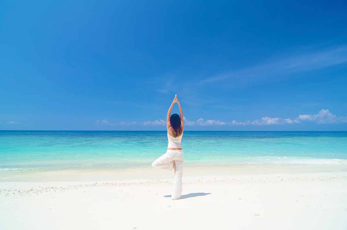 Beaches in Malaysia east woman doing yoga on the beach