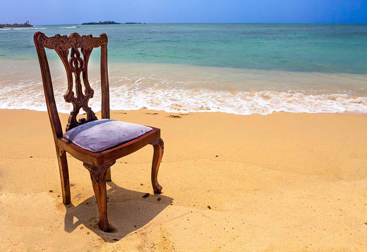 Best beaches in Sri Lanka November an old wooden chair on Unawatuna Beach.