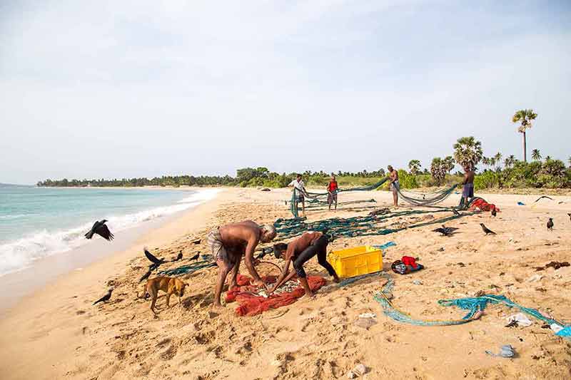 Best surfing beaches in Sri Lanka Fishermen at Nilaveli Beach in Trincomalee