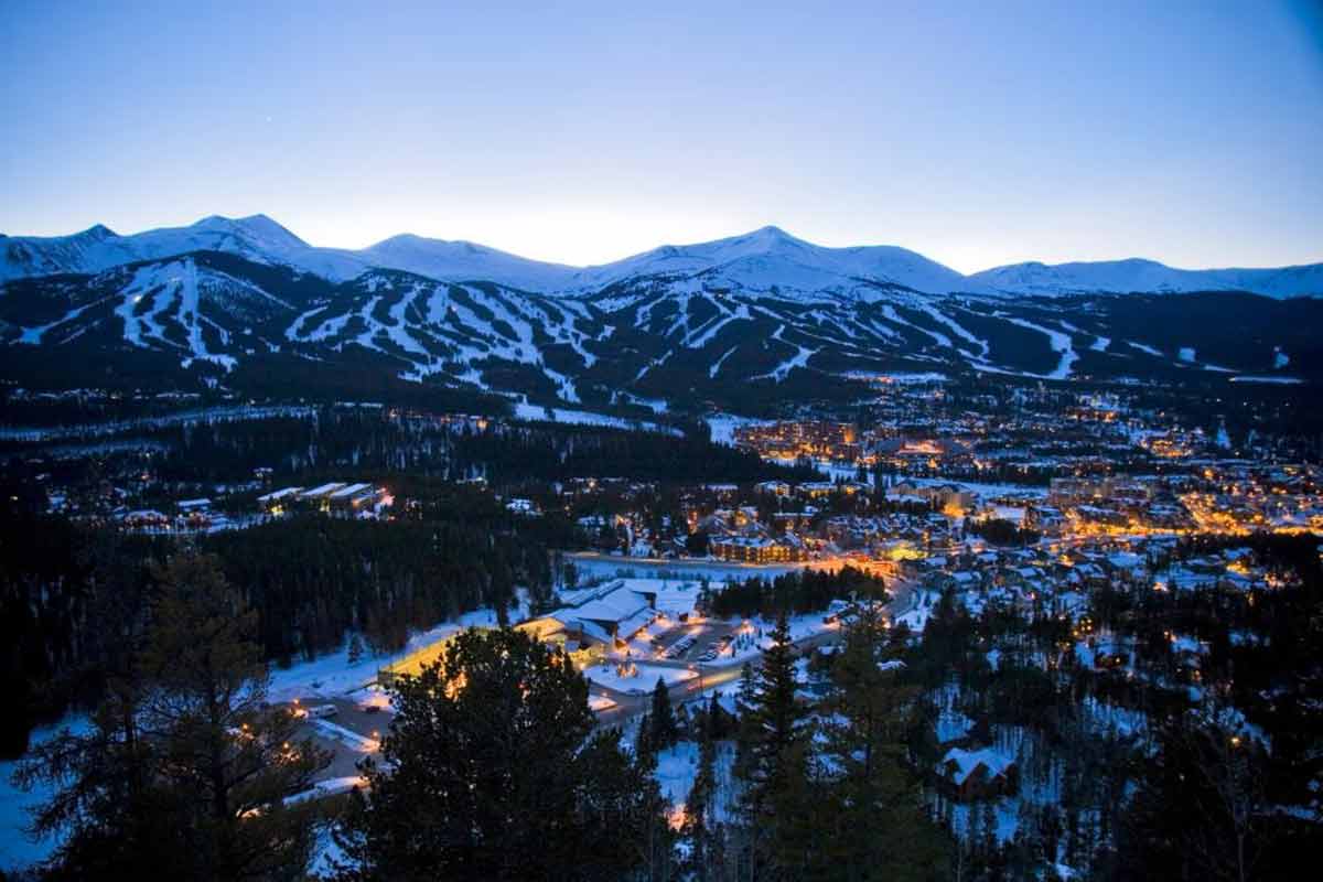 Breckenridge at night with town lights and mountains in the background