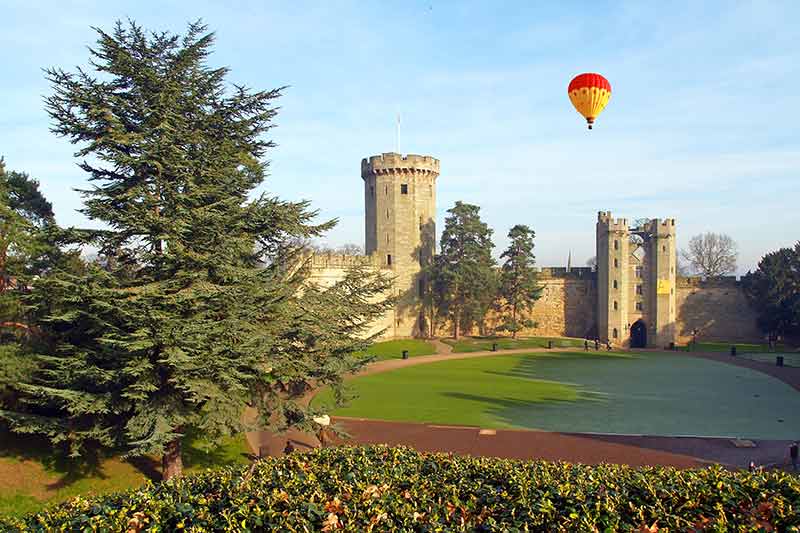 Castles Near London (Warwick Castle with hot air balloon over the garden)