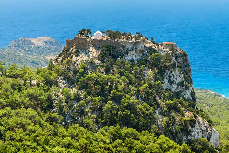 Castles in Greece (Monolithos) high on a hill with the ocean in the background