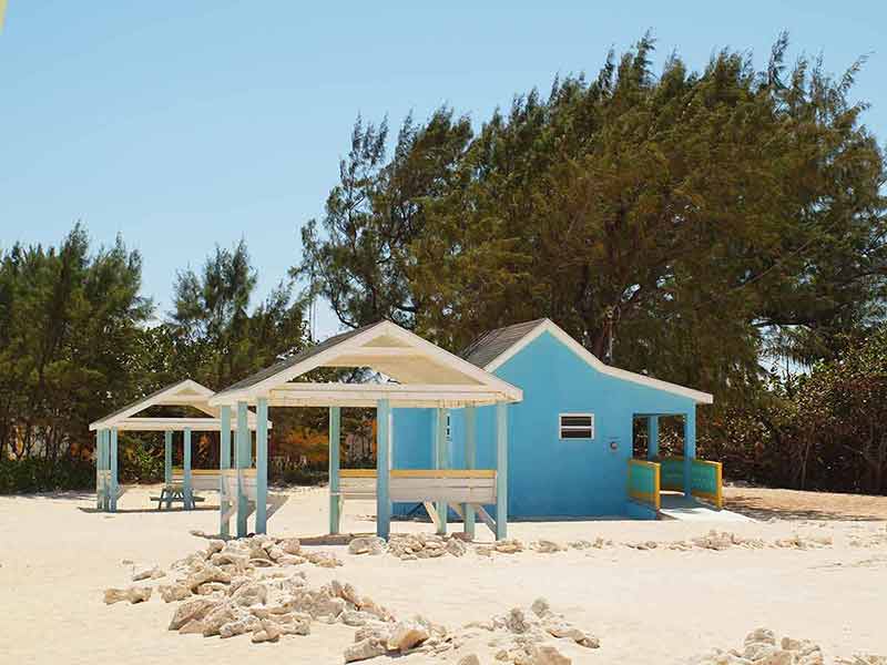 Cayman Island beaches Colliers Public Beach blue building and cabanas