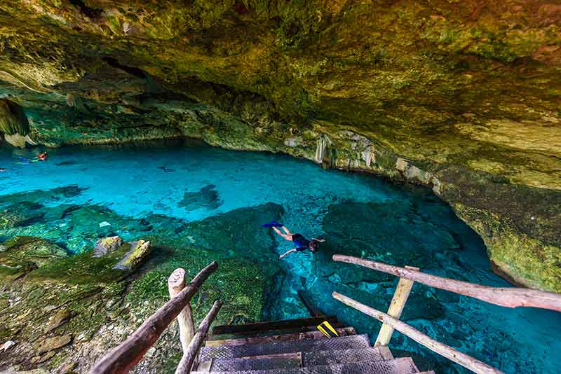 Cenotes in Mexico dos ojos rustic staircase leading into the water
