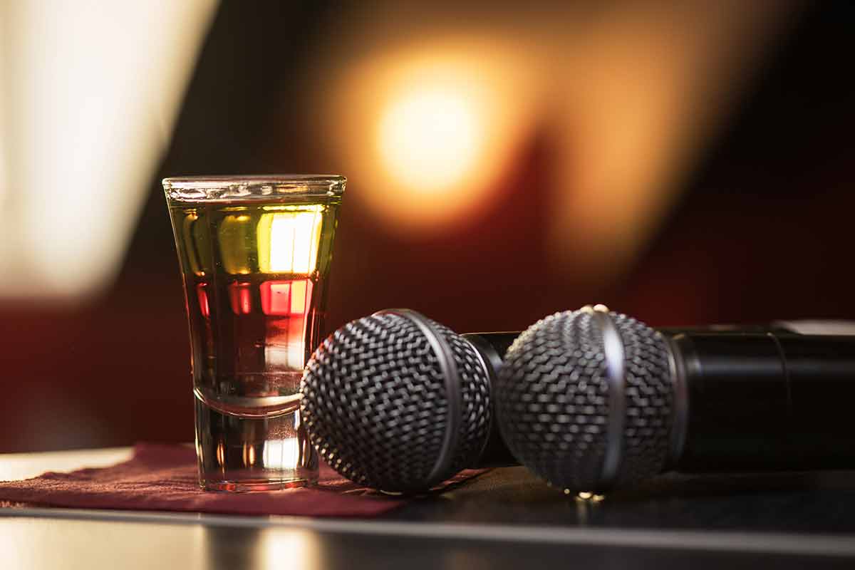 Closeup photo in a bar with burning drink shot and two microphones