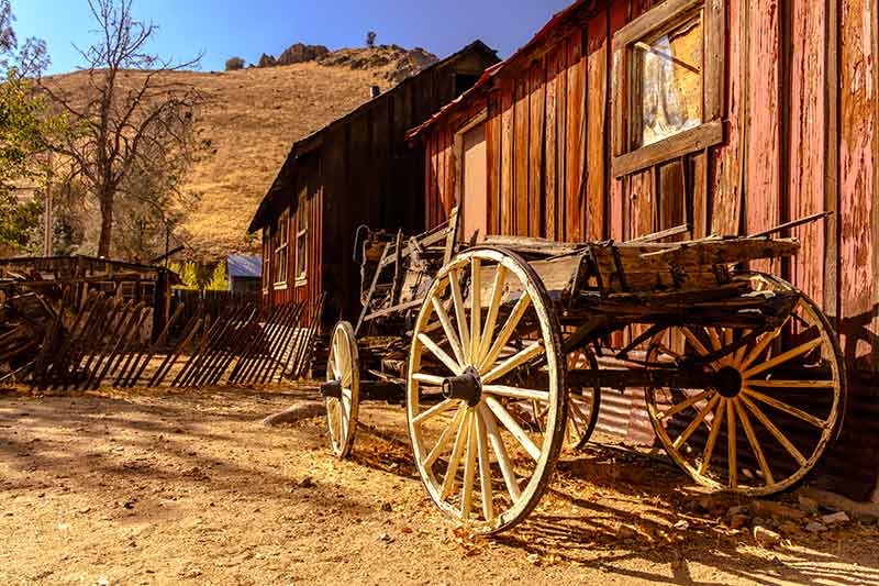Ghost towns of California Silver City old wagon beside a barn