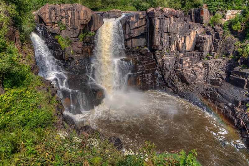 Dramatic waterfalls cascading down a rock face at Grand Portage State Park Minnesota