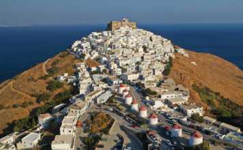 Greek Castle Chora of Astypalaia on a hill with white houses in the foreground