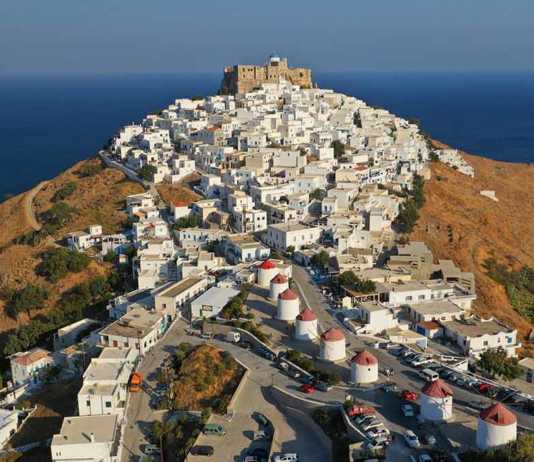 Greek Castle Chora of Astypalaia on a hill with white houses in the foreground
