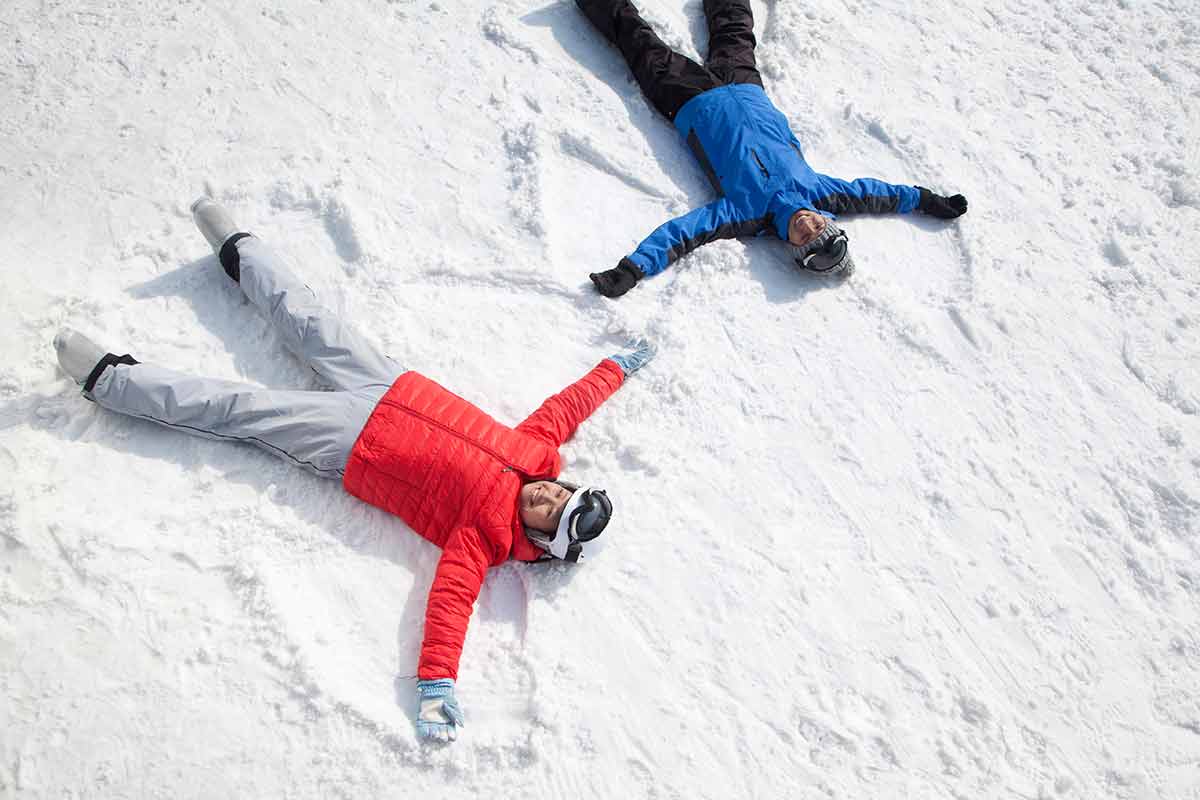 How is Christmas celebrated in China Couple lying on snow making snow angel