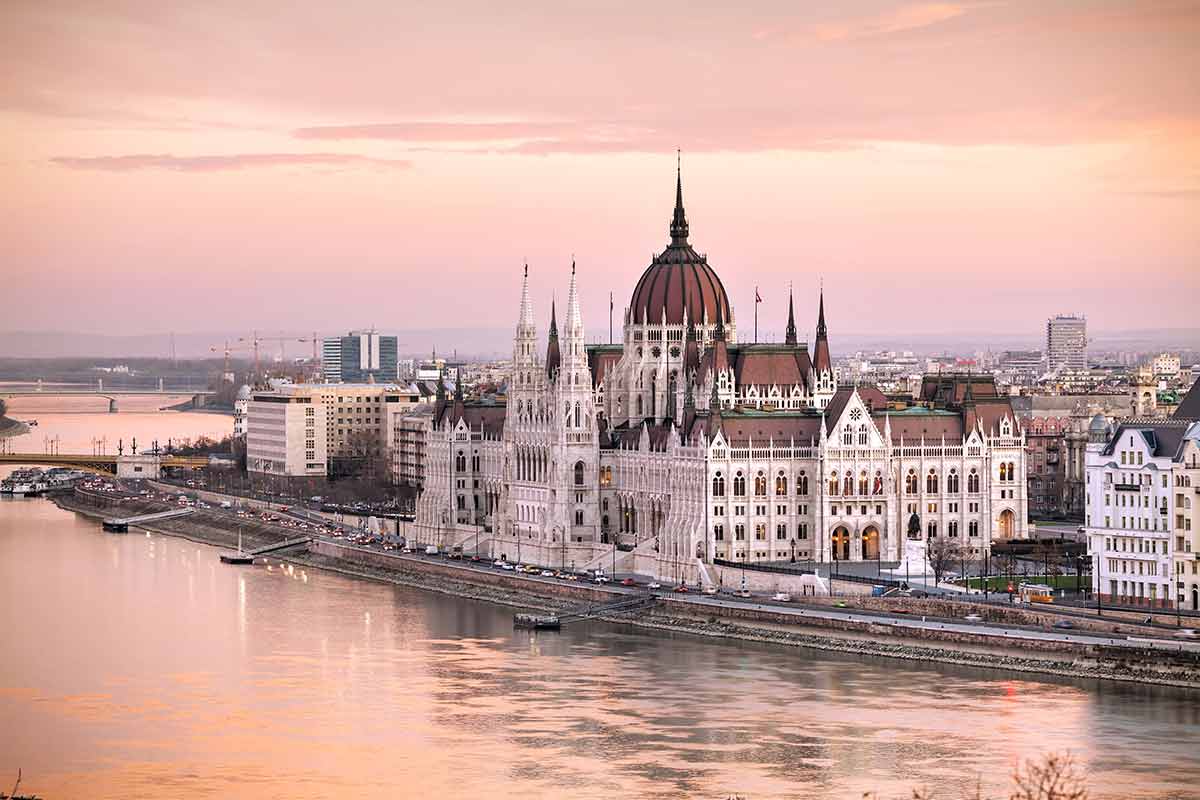 Hungarian Parliament on the Danube River at dusk
