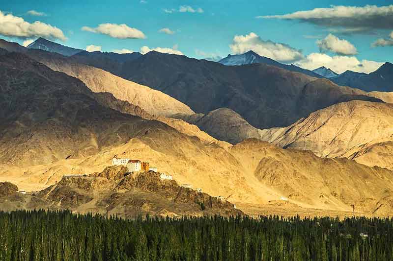 India mountains thiksey monastery wide view of monastery with huge mountains in the background