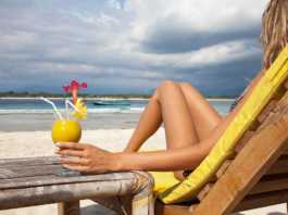 Indonesia beaches woman on a beach lounge with a mango cocktail
