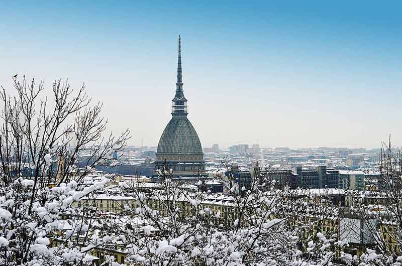 Italy in winter antonelliana and turin's snow-covered rooftops