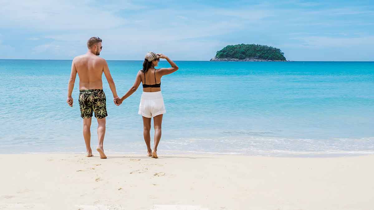 couple back view holding hands on Kata Beach