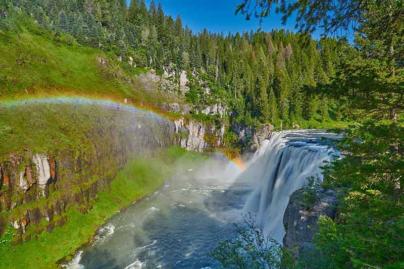 Landmarks in Idaho - rainbow over Upper Mesa Falls near Ashton