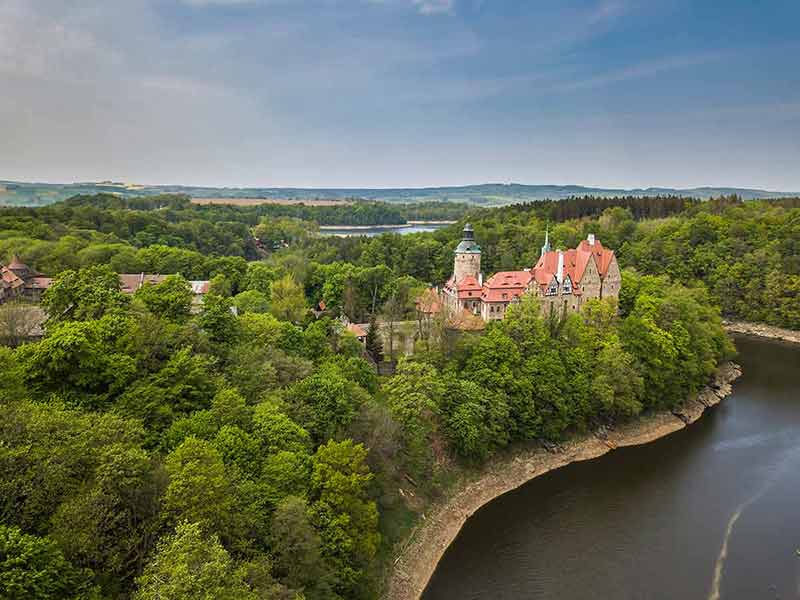 Czocha castle sits by a river