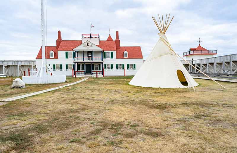 North Dakota National Parks Fort Union Trading Post National Historic Site teepee and white historic building