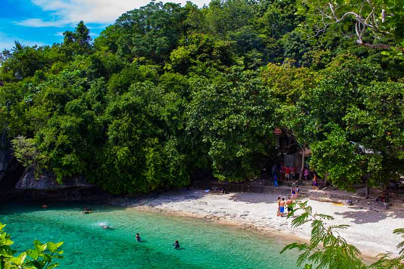 Salagdoong Beach with clear water, white sand and people