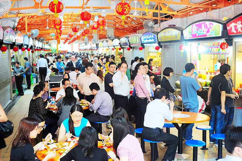 Singapore street noodles in hawker center, locals eating at a popular food hall in Singapore.