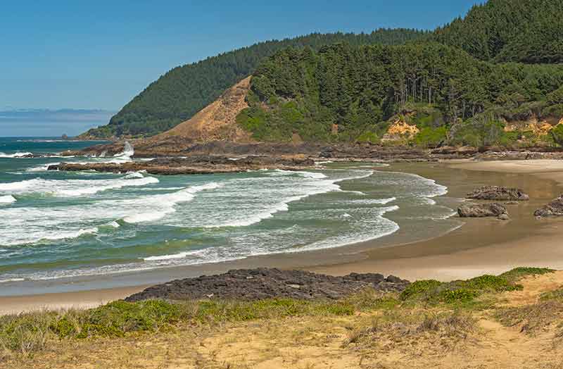 Strawberry Hill Beach Oregon with green covered cliffs