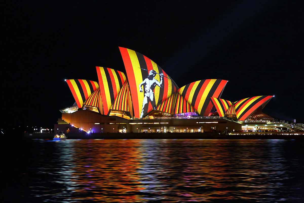 Sydney at night aboriginal man throwin spear projected on the Sydney Opera House