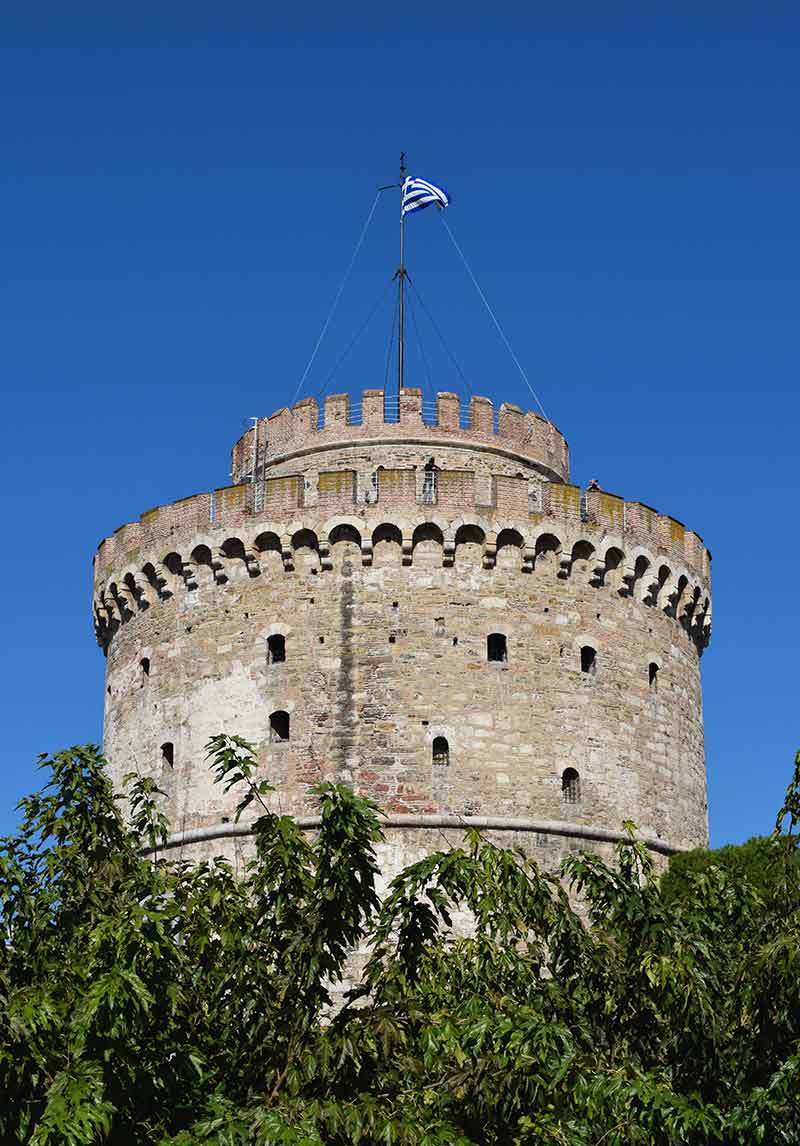White Tower with flag on top and blue sky
