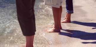 Wisconsin Beaches three pairs of legs standing in the water