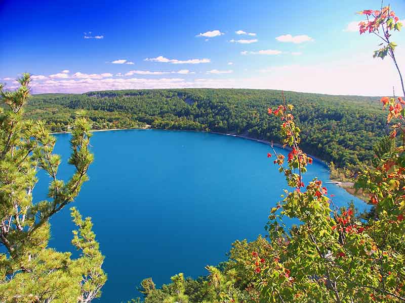 blue Devil's Lake framed by lush trees