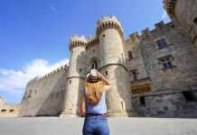 active things to do in rhodes back of tourist girl visiting the Palace