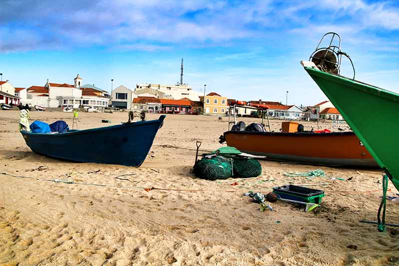 aguda beach portugal colourful fishing boats on the sand