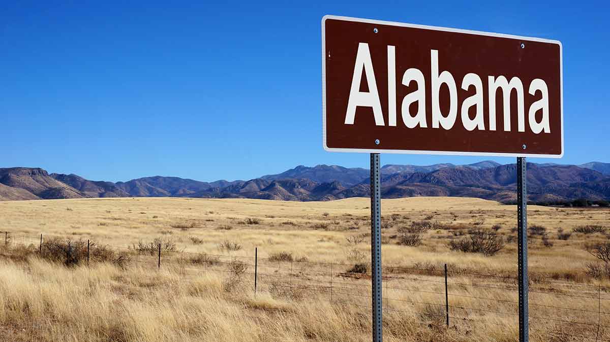 alabama major landmarks Alabama road sign with blue sky and wilderness