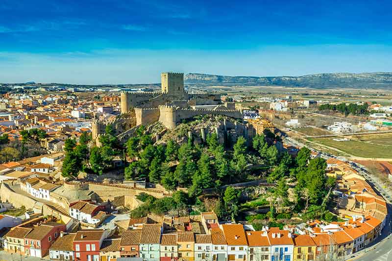almansa castle in spain surrounded by colourful houses