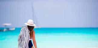 anguilla beaches woman wearing white straw hat looking out to sea