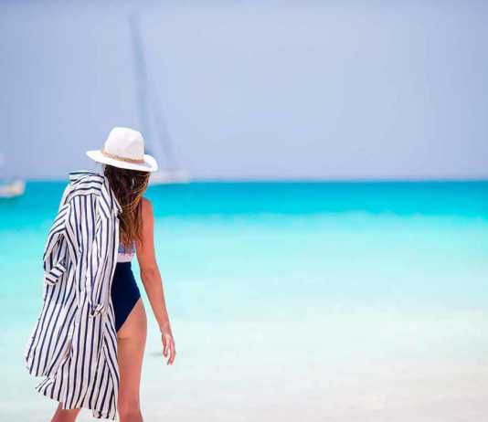 anguilla beaches woman wearing white straw hat looking out to sea