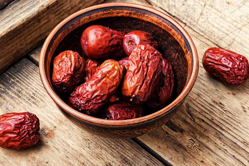 asian fruits jujube in a bown on a wooden table